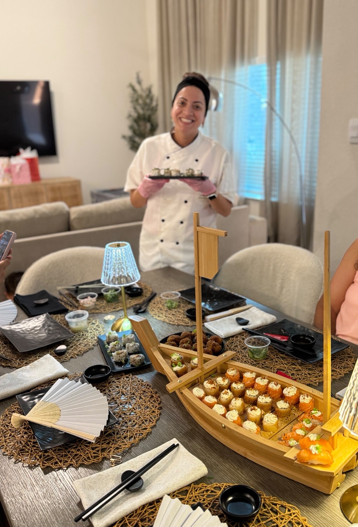 Chef Barbara smiling while presenting sushi at a private event